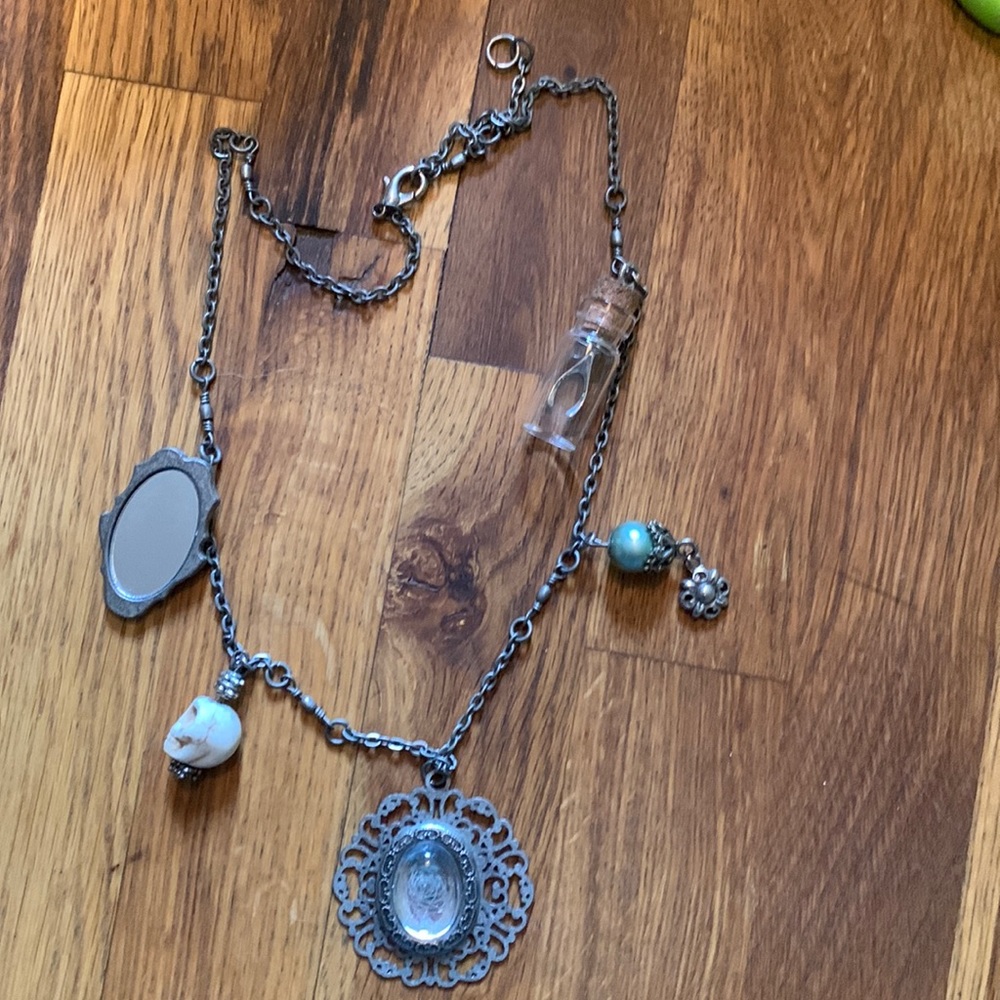 Necklace, with mirror, skull, rose and wishbone.